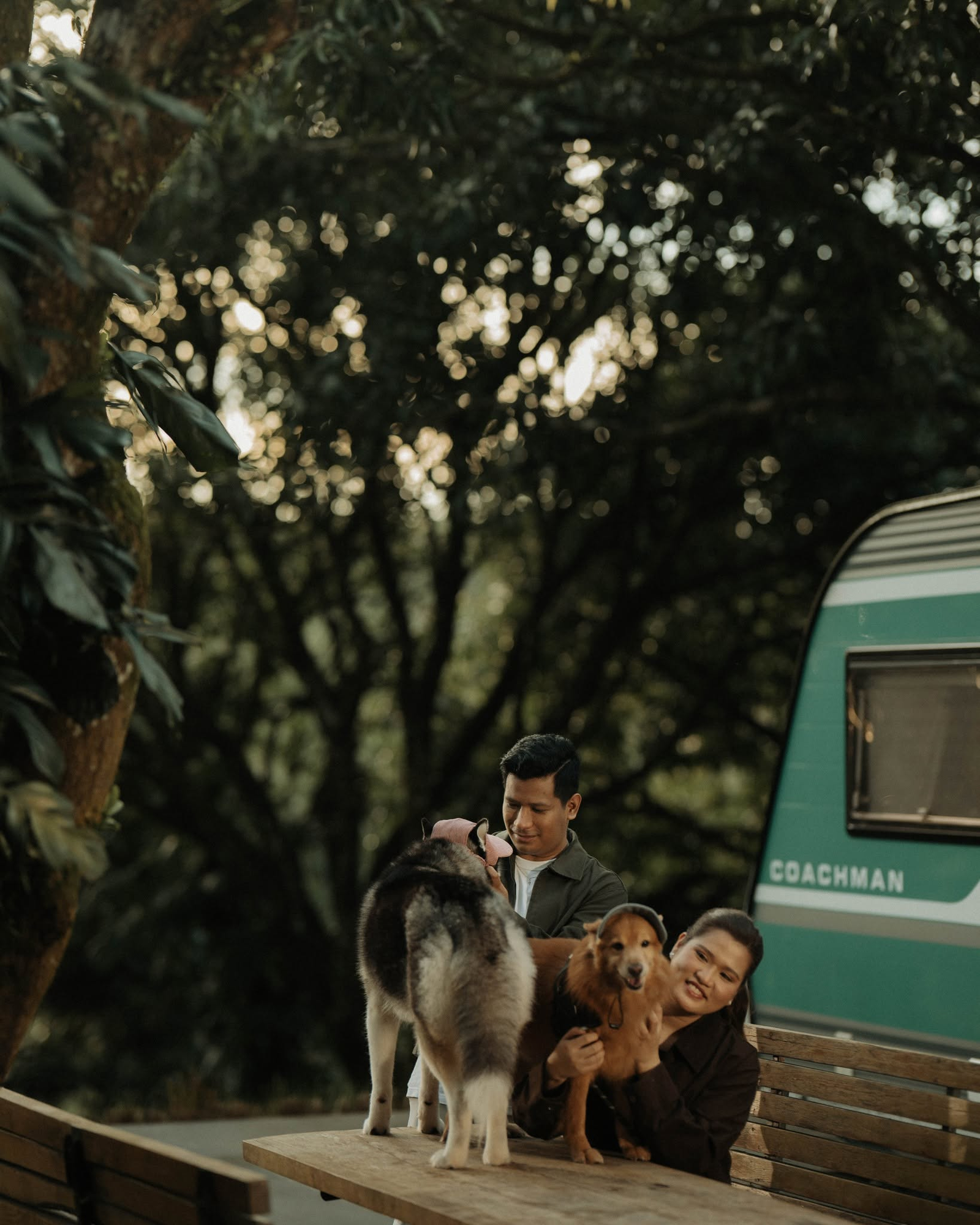 Dan and Angela with their dogs on a bench