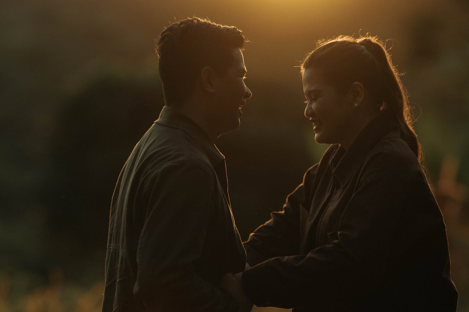 Dan and Angela smiling at each other