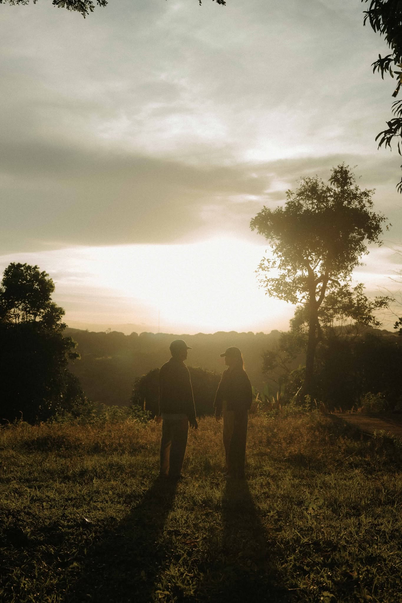 Dan and Angela standing together at sunset